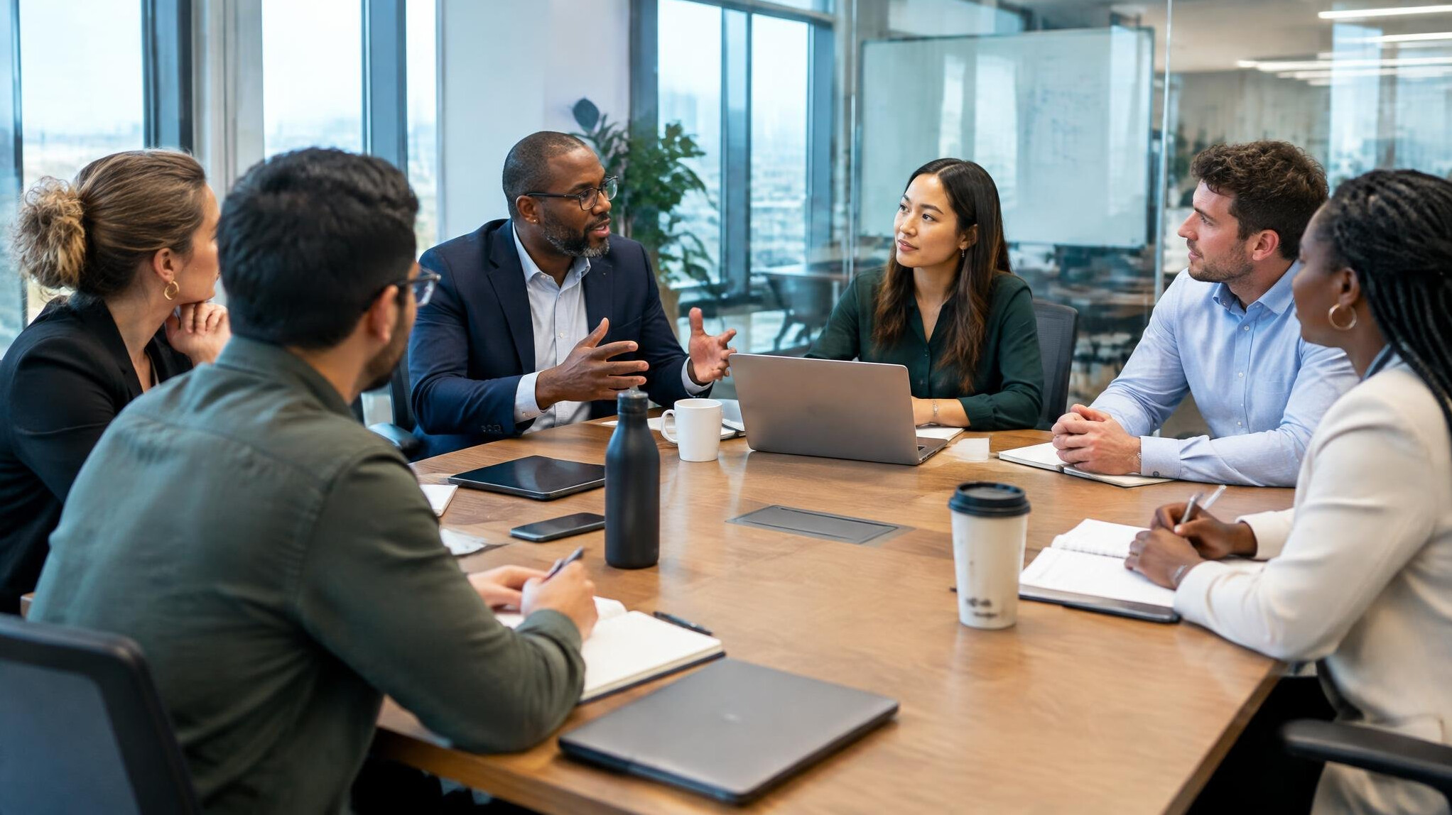 Group discussion in a glass walled meeting room