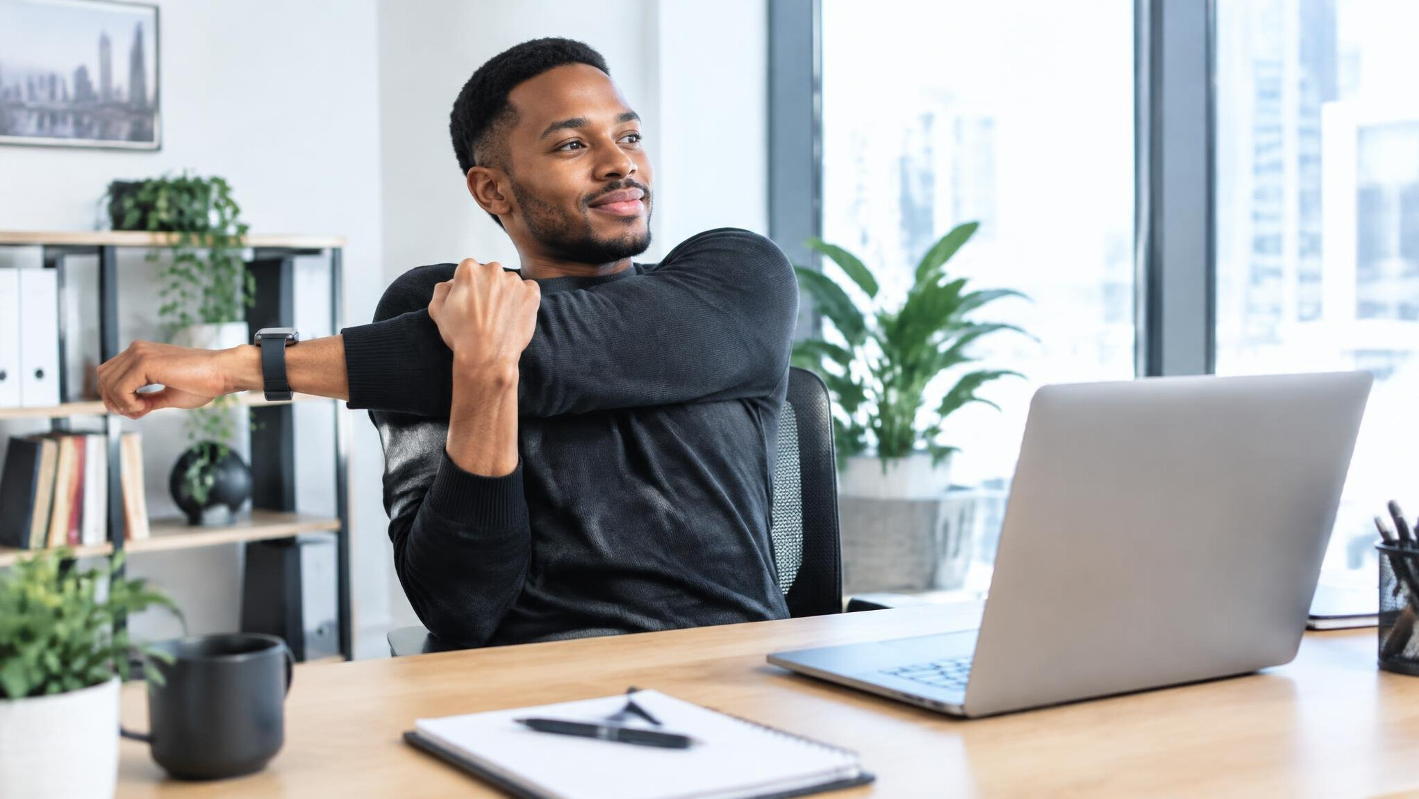Person stretching at their desk for a work break